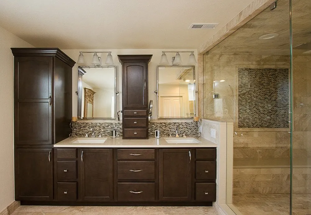 BB1-1-1920w Beautiful Denver master bathroom remodel. Custom dark wood cabinetry, marble walk-in shower with shower bench, marble countertops with backsplash and modern light fixtures.