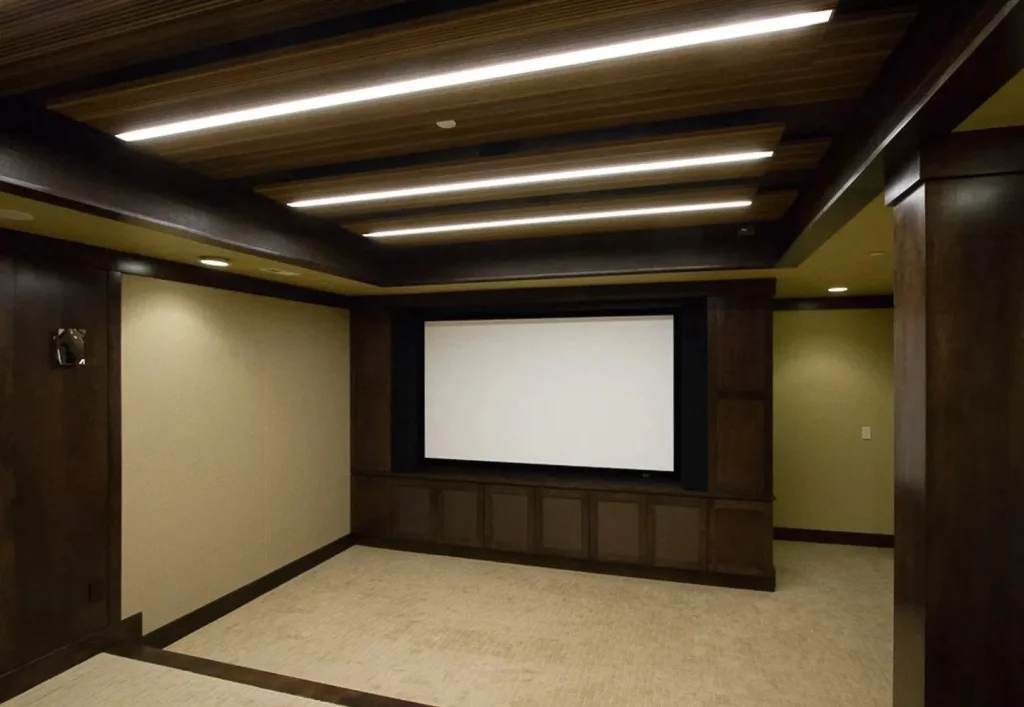 CD8G0060 Castle Pines home theater remodel. Custom modern lighting, built-in screen perfect for a personal movie theater. Dark wood details and fixtures. Castle Pines home theater whole house remodel.