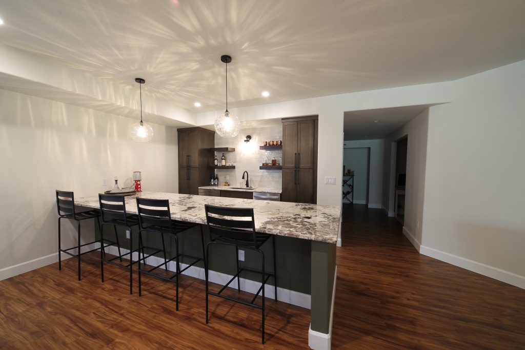 CD8G0076 Colorado Elite basement finished with wet bar, marble countertops, modern light fixtures and hardwood floors.