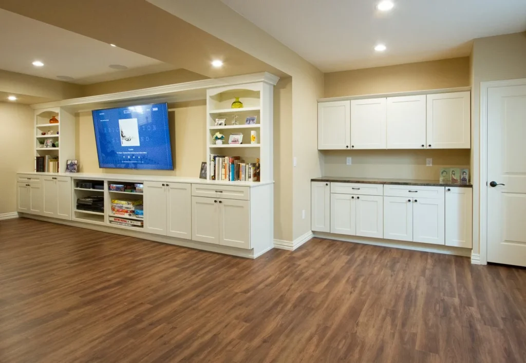 W2-e5a68c0d-1920w Modern Alcott Street basement refinish with hardwood floors, white cabinetry built-in shelving, modern lighting and open floor plan.